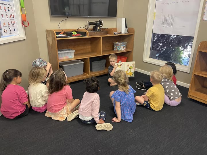 A child sharing a story with a group of friends