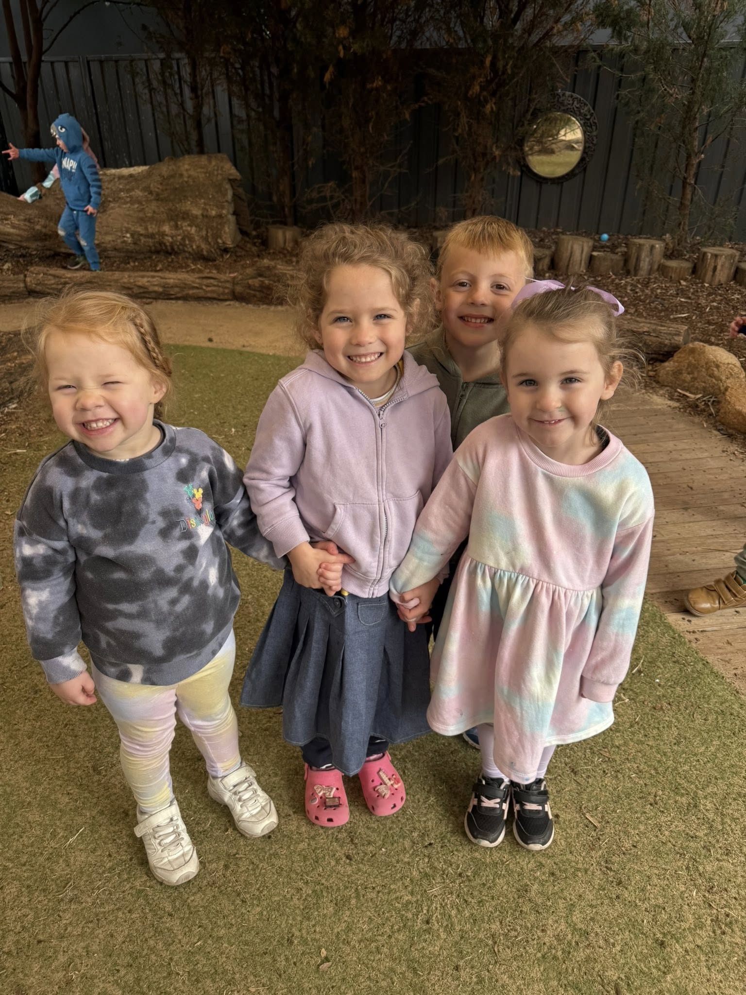 A group of friends smiling together in the Dubbo outdoor play space